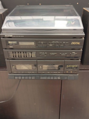 Silver vintage stereo system with turntable, radio, double cassette deck