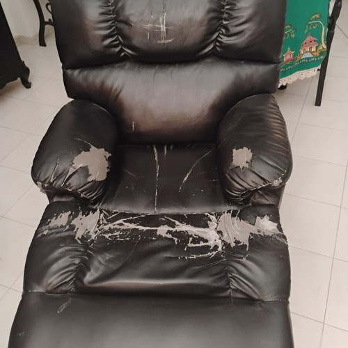 Relax massage armchair with visible wear
