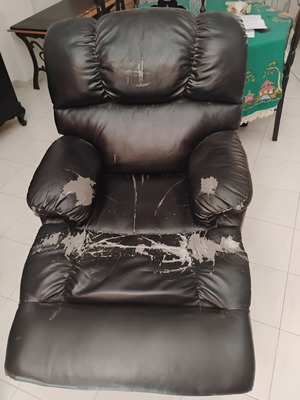 Relax massage armchair with visible wear