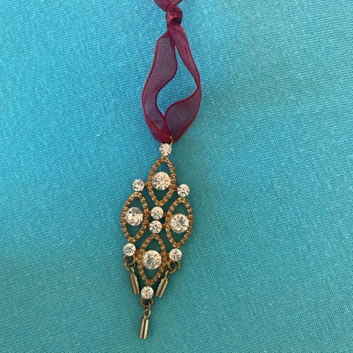 Gold pendant like new with sparkling rhinestones