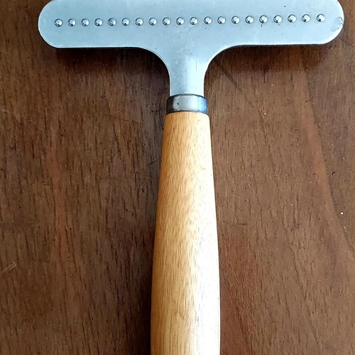 Grooming rake like new with metal teeth and wooden handle