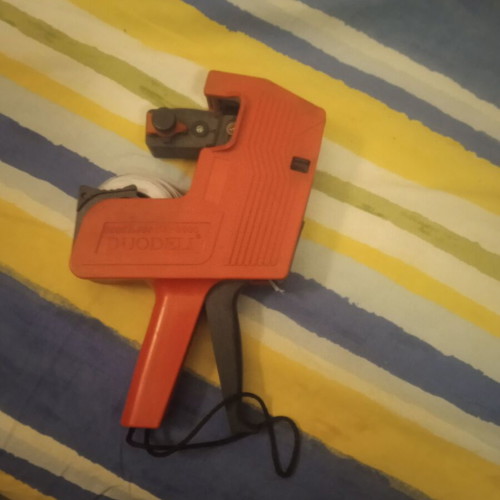 Handheld price machine used, red labeler