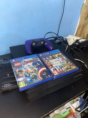 PS4 Pro 1TB black console with one controller and two games