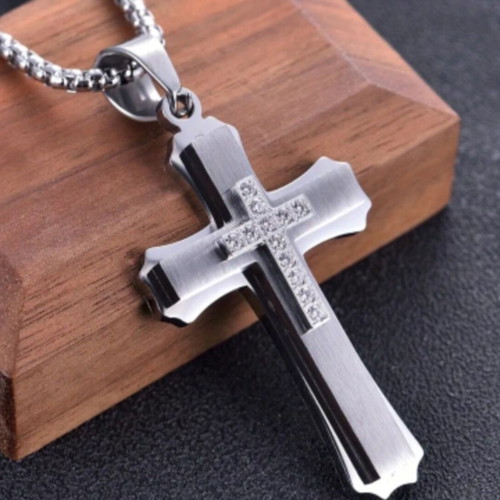 Elegant cross pendant with decorative stones and chain