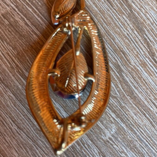 Decorative pin like new, gold and purple, missing two purple stones