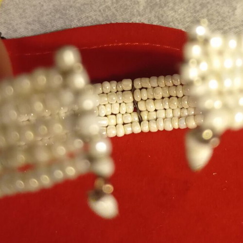 Vintage bracelet used with multiple rows of tiny white beads