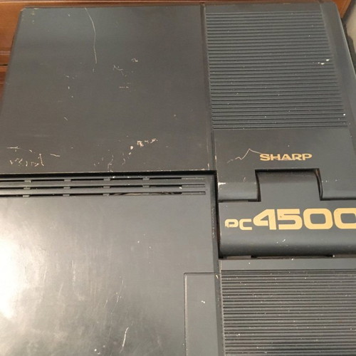 Sharp PC-4500 laptop collectible with charger