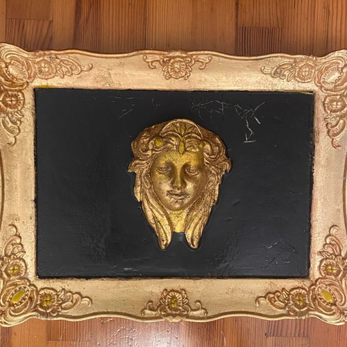Gold-colored relief head wall art with black background, new