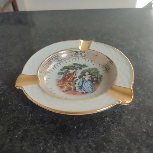 Vintage porcelain ashtray used with romantic scene and gold details