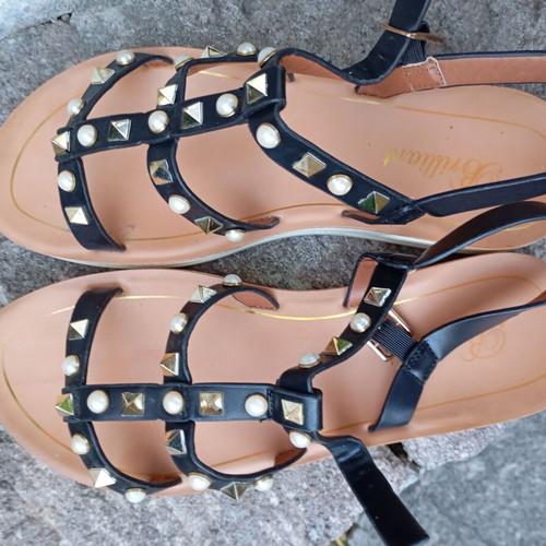 Brilliant black flat sandals with studs and pearls