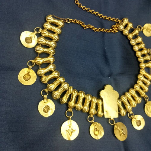Traditional necklace with vintage symbols used, yellow light color, copper