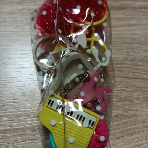 Vintage pins with piano, glasses, bicycle, tennis racket, animal designs