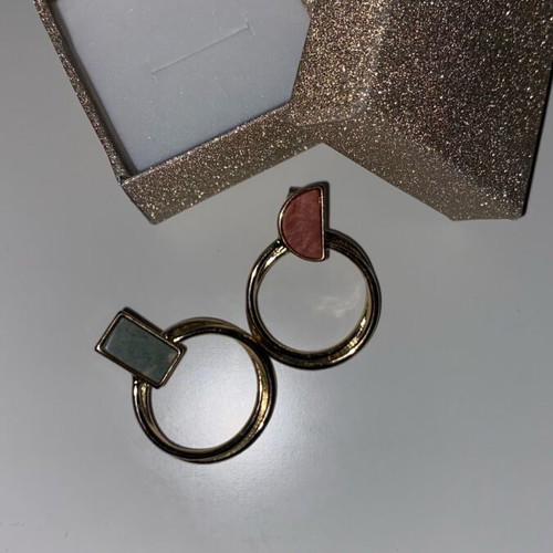 Gold hoop earrings used with detail on top part