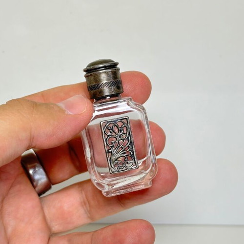 Vintage glass perfume bottle with metal decoration