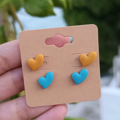 Heart-shaped polymer clay earrings with steel posts, orange and turquoise