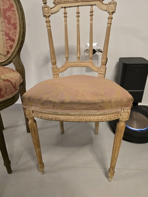 Handmade antique chair with fabric and carved wood