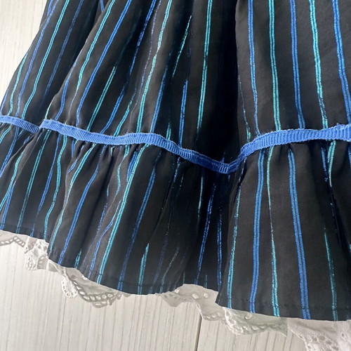 Girls' skirt used, black fabric with blue metallic stripes and lace, 4-5 years