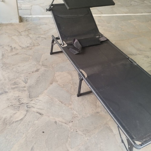 Black sunbed with moveable umbrella and comfort pillow like new
