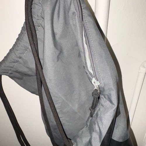 Nike sports backpack with straps and side pocket, black and grey