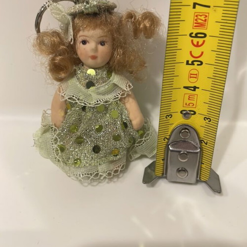 Porcelain doll keychain like new, green, 7cm with movable arms and legs