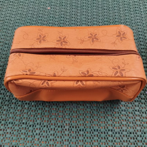 Women's cosmetic bag with floral punch-out design, synthetic leather, camel