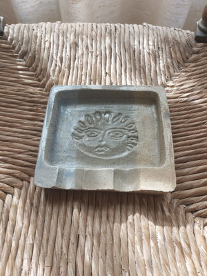 Handmade ceramic ashtray used with embossed face design