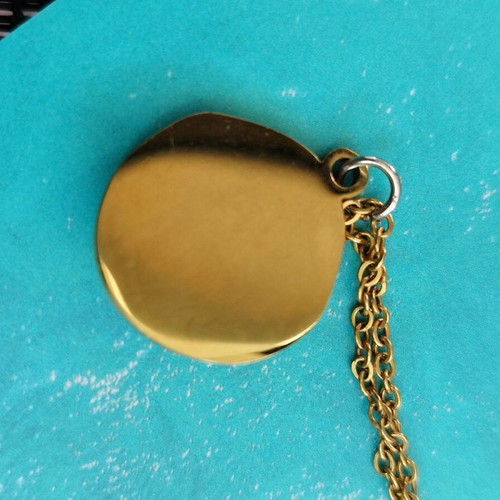 Steel necklace like new with blue mataki stone gold color