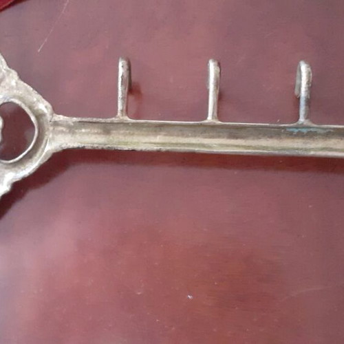 Vintage brass key-shaped hanger used, decorative wall hook