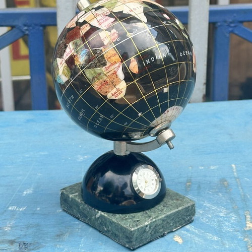 Decorative globe made of semi-precious stones with clock and marble base used