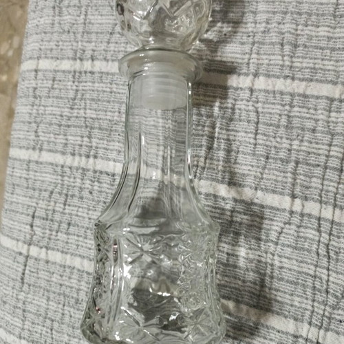 Vintage glass bottle like new with embossed designs and stopper