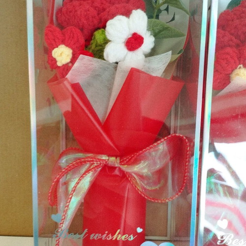 Artificial flower bouquet like new with knitted flower and plastic leaves