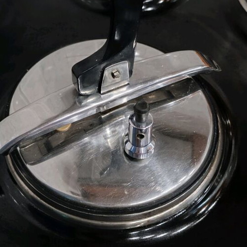 Pressure cooker used, old style, stainless steel with safety lid