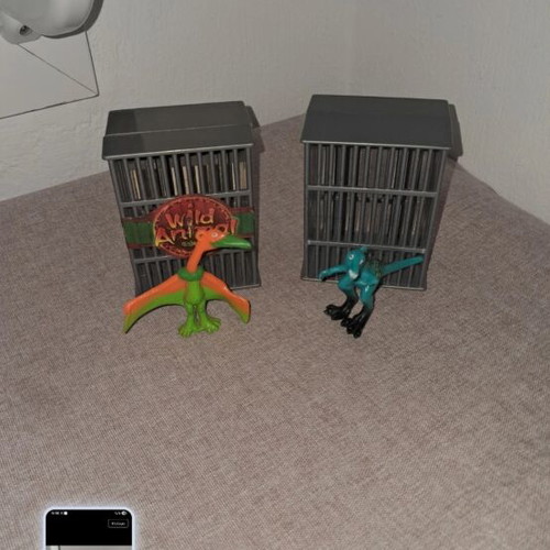 Dinosaur figures used, set in cages