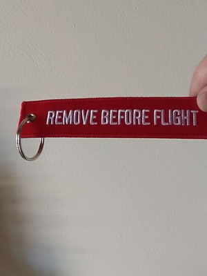 Remove Before Flight keychain new, red