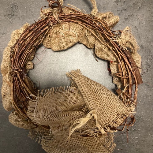 Christmas wreath made of natural materials with knitted handle