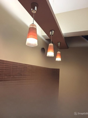Wall-mounted bar set like new with stools and wooden surface
