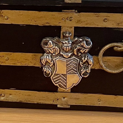 Antique wooden chest used with medieval emblem
