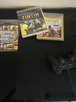PlayStation 3 console with 3 games: GTA 5, Tin Tin, Assassins Creed