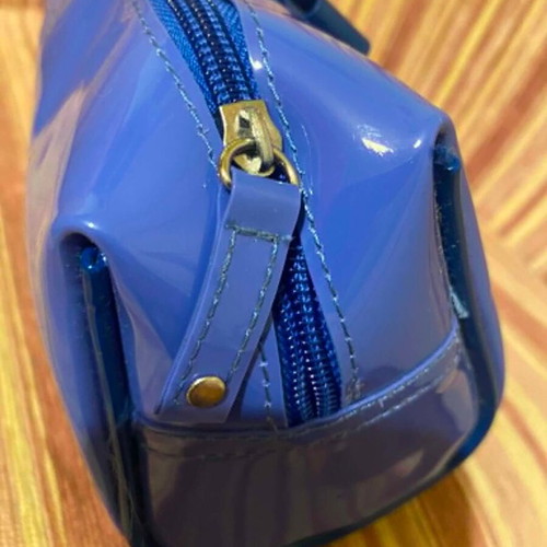 Shiny blue toiletry bag with decorative bow, like new