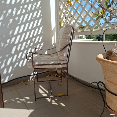 Retro wrought iron garden armchair with cushions used