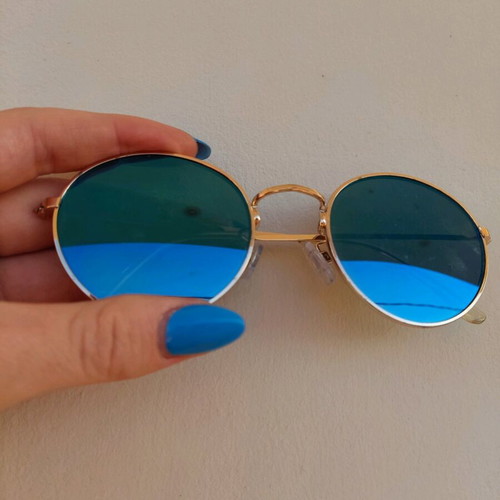 Sunglasses with blue mirror lenses and gold frame