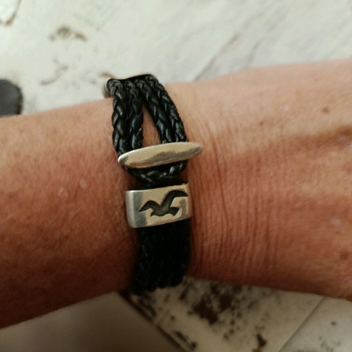 Black leather-type bracelet with silver elements used