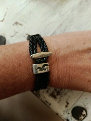 Black leather-type bracelet with silver elements used