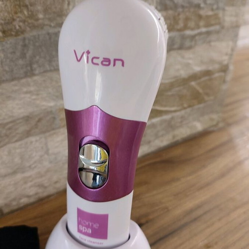 Facial cleansing device used with two heads and stand