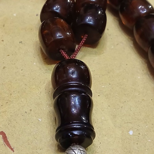 Amber worry beads used with silver elements and tassel