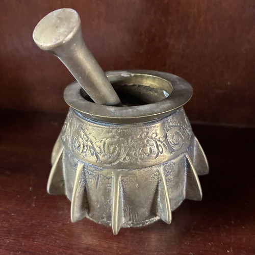 Bronze mortar and pestle used, antique with ribs and engraved design