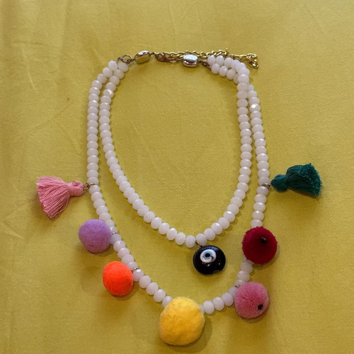 Necklace with white stones, evil eye, pom poms and tassels used