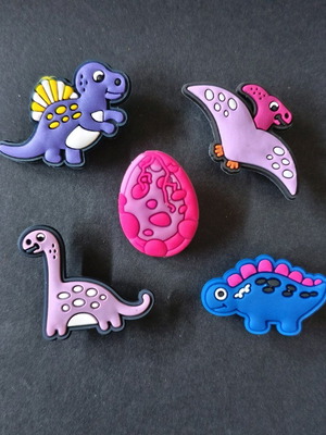 Crocs charms set with pink multicolored dinosaurs like new