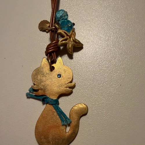 Cat design necklace like new, double brown leather cord with blue beads