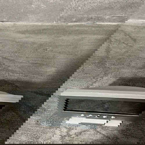 Digital table clock used with alarm and thermometer